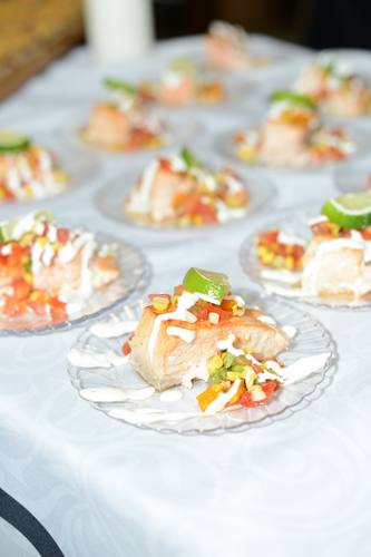 Salmon bite topped with bright corn salsa