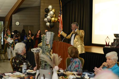 Emcee raising his arms triumphantly during the awards segment