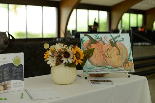 Corn-stalk mural backdrop with harvest decor