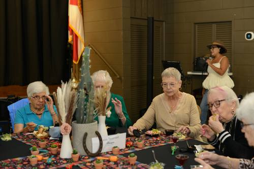 Seniors seated together at a festively decorated fiesta table