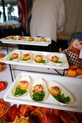 Fried seafood rolls plated over seaweed salad with roe