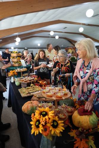 Guests sample dishes at the sunflower-decorated tasting table
