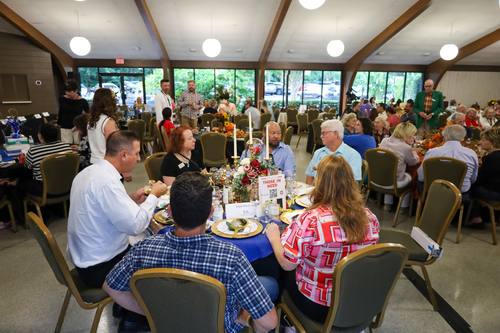 Wide view of the banquet hall full of mingling guests