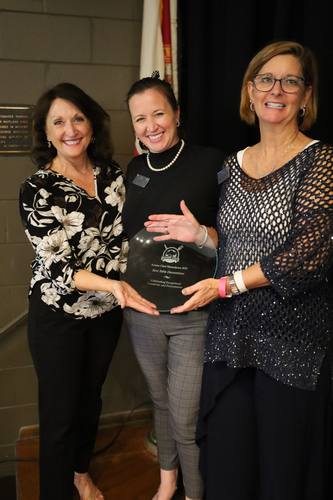 Three women proudly hold the "Best Table Decorations" award