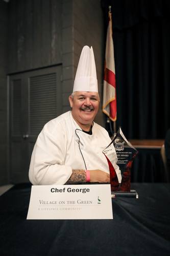 Chef George beams beside his Judges' Award trophy