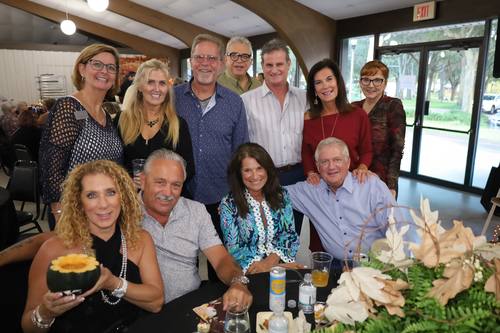 Large group of guests gathers for a joyful photo